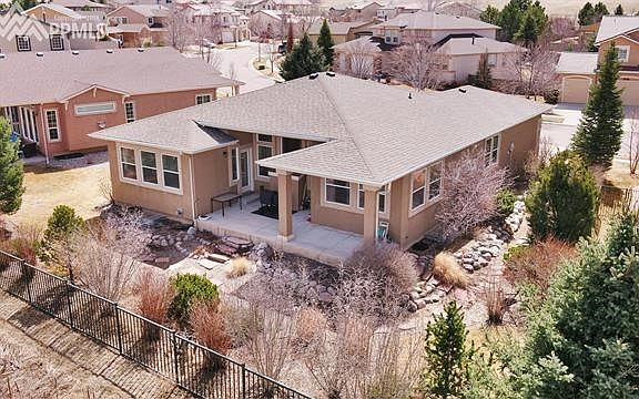 Mature landscaping note covered patio.