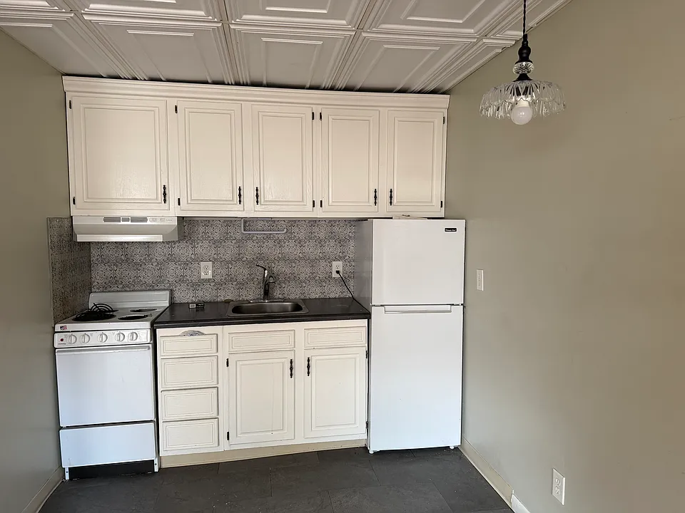 Kitchen with refrigerator/freezer and range.
