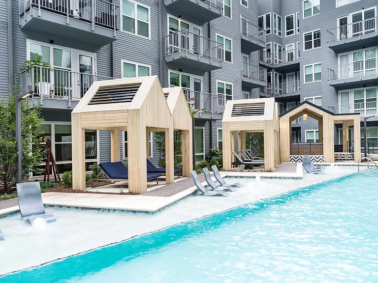 Poolside cabanas at Modera Old Ivy offer shaded lounging, in-water seating, and a polished courtyard setting designed for relaxed Atlanta days.