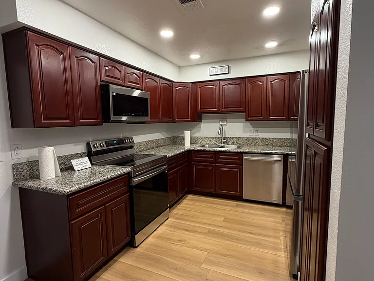 Spacious kitchen with granite countertops, stainless steel appliances, and abundant cabinet space.