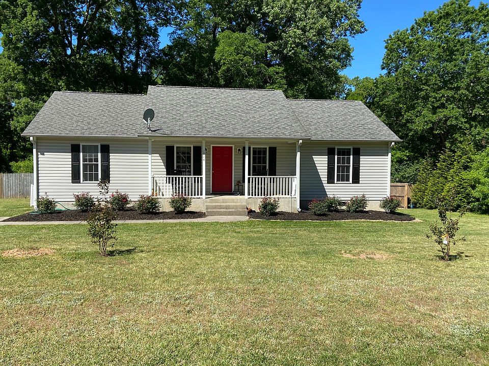 Front of Home- Front door is now black and has a storm door.