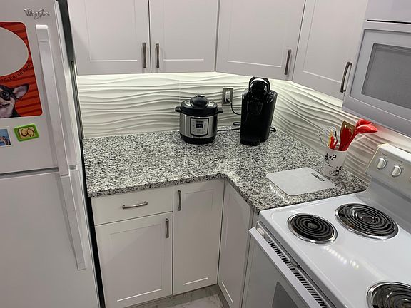 New granite countertop, new stainless sink, faucet, cabinets, and up and down lighting.
