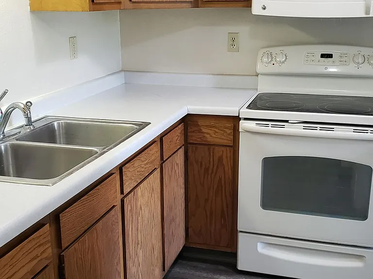Kitchen includes smooth-top range oven and microwave
