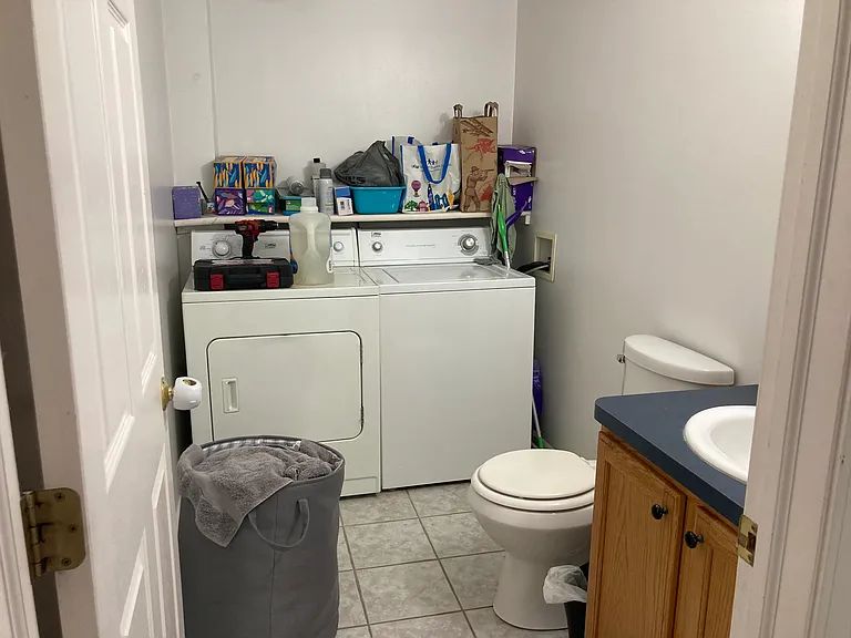 Half bath and full sized laundry equipment.