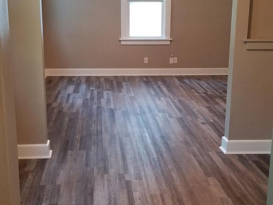 View looking into Dining Doom and Living Room - Nice size rooms and new flooring and Ceiling Fans
