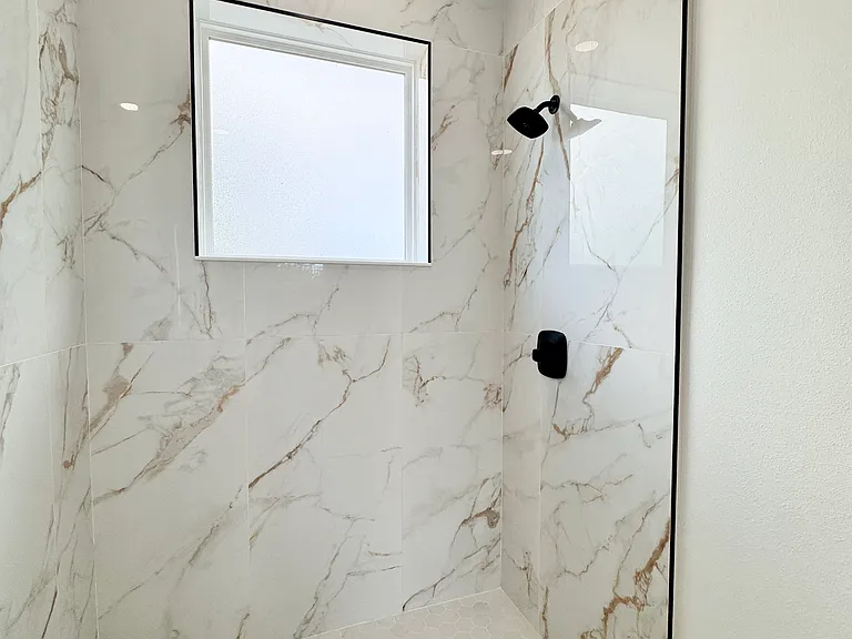 Beautiful floor-to-ceiling tiled walk-in shower.