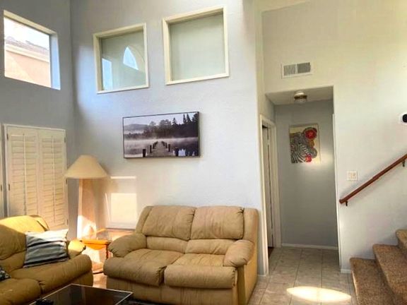 Living room with high ceiling and big windows
