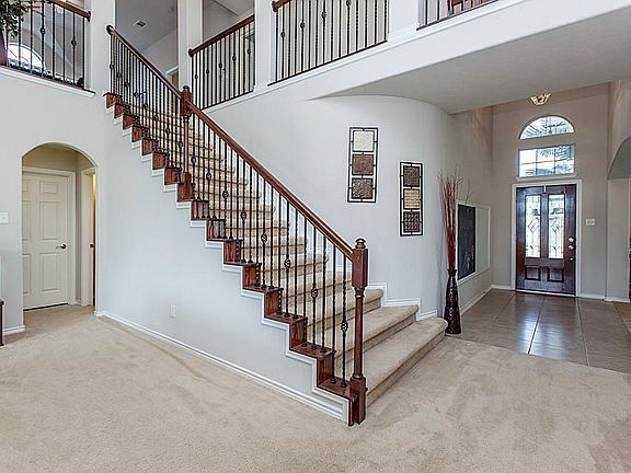 LEADED DOOR ENTRY WITH TILED FLOORING ~ WROUGHT IRON STAIRWAY AND WALKWAYS ~
