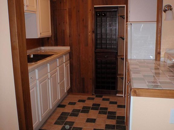 Full wet bar with refrigerator & wine storage off of living
