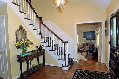 Two story foyer with turned staircase