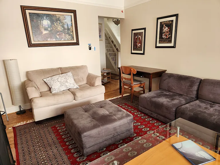 Spacious, sunny living room, plentiful comfortable seating; desk