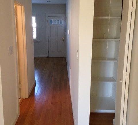 Bathroom on left, front door, closet on the right. Note: limited closet space. Clothes cabinet provided in front room and additional cabinet storage in garage and laundry area (upstairs)