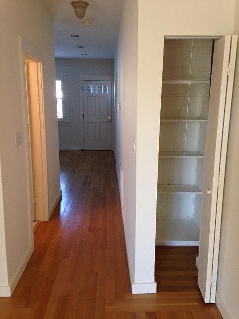 Bathroom on left, front door, closet on the right. Note: limited closet space. Clothes cabinet provided in front room and additional cabinet storage in garage and laundry area (upstairs)
