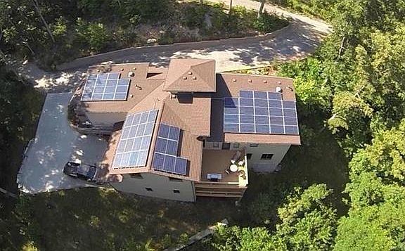 Overlooking the rear of the house and dual decks. Mostly wooded private one acre  lot.