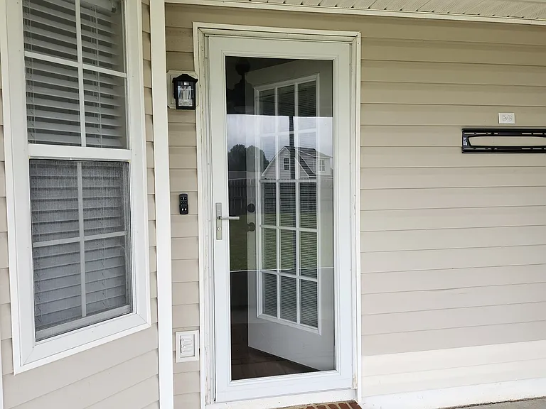 Exit from the Great Room/Kitchen Area to the backdoor. This is the covered porch area.