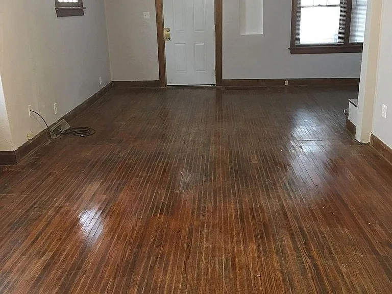Large, open concept living room with authentic hard wood flooring and wood trim