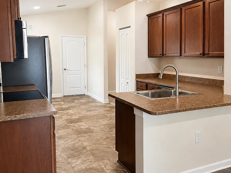 eat in kitchen with room for additional storage or breakfast nook on other side of fridge. full pantry as well.