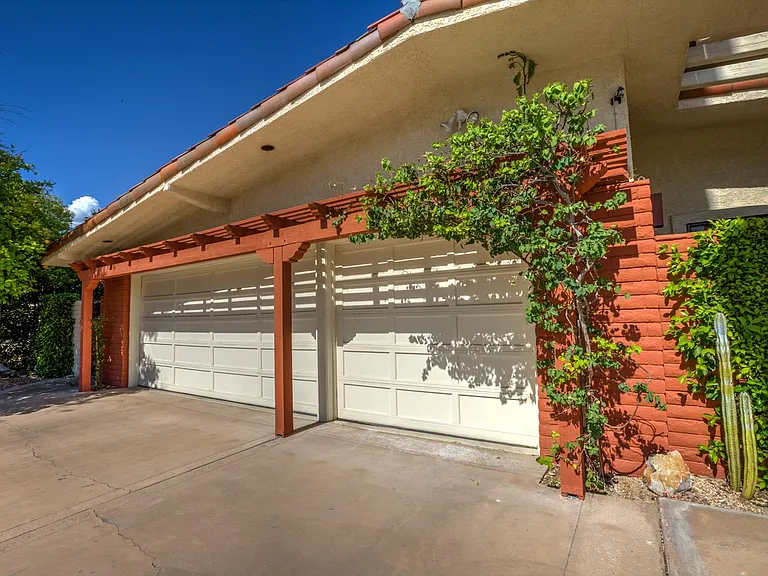 Spacious garage fits two cars and one smaller car or golf cart.
