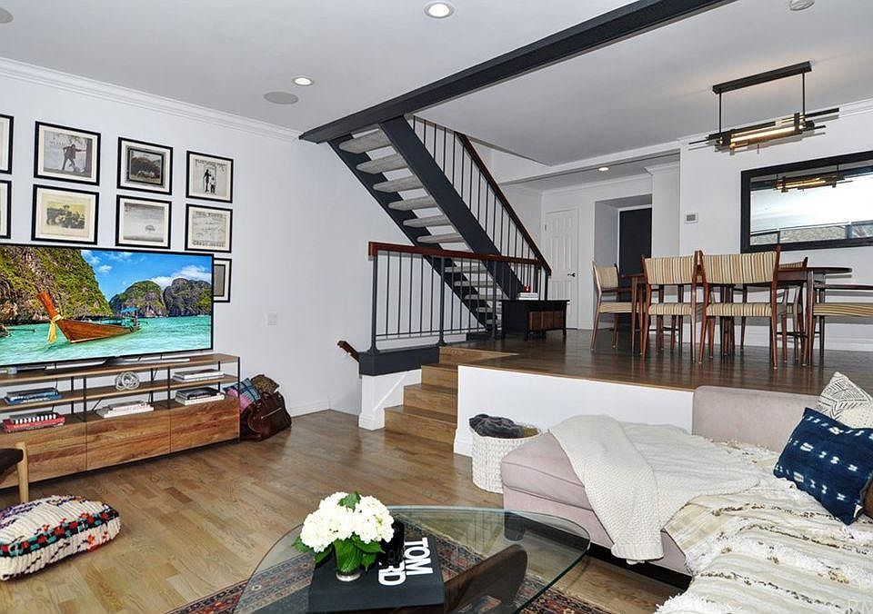 Living room leading down to garage or up to top floor