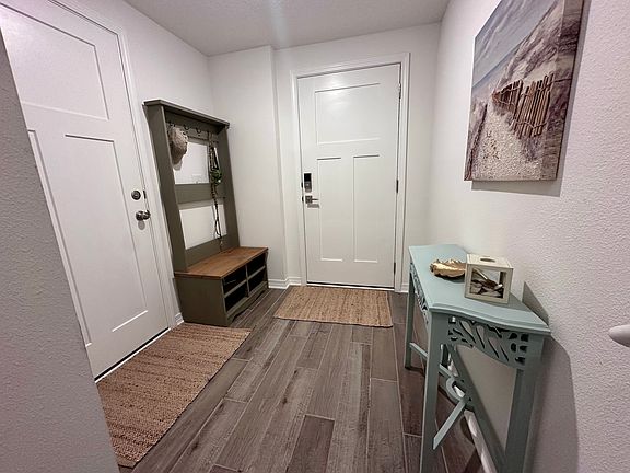 Entry vestibule with space to drop bags, hang hats and dog leashes, and set sandy shoes.