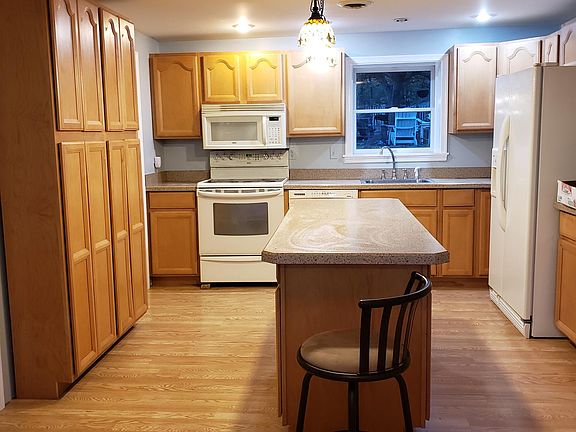 Large kitchen with center island for food preparation.
