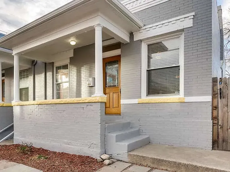 The front of this charming home has an elevated covered porch