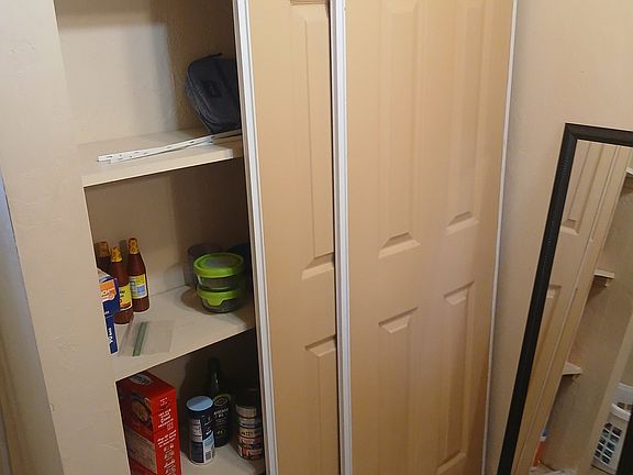 As you face the bath vanity mirro, this closet would be behind you