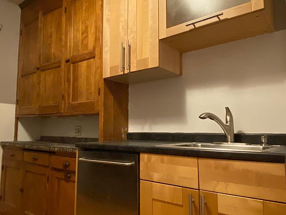 Spacious galley walk-through kitchen combines old-world charm with modern conveniences.