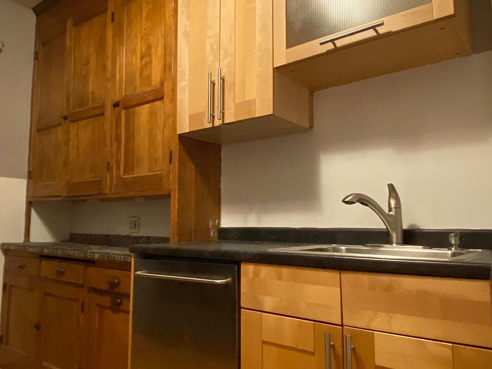Spacious galley walk-through kitchen combines old-world charm with modern conveniences.