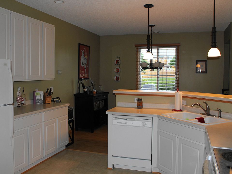 Spatious kitchen with recessed and pendant lighting