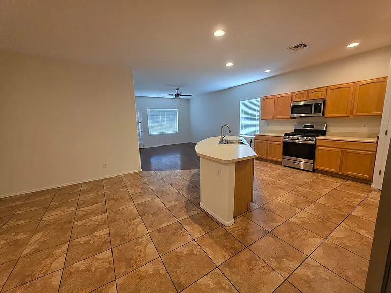 Kitchen with living room view and dining area.