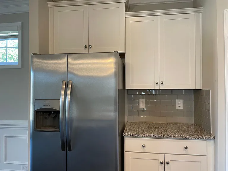Coffee bar nook. Stainless refrigerator with water and ice dispenser.