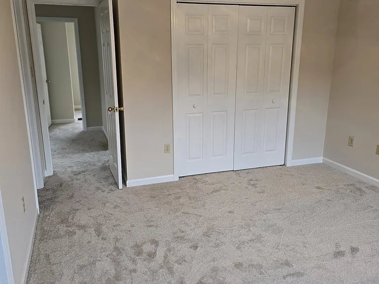 Master bedroom w/ 2 closets. This closet entire width of wall inside.