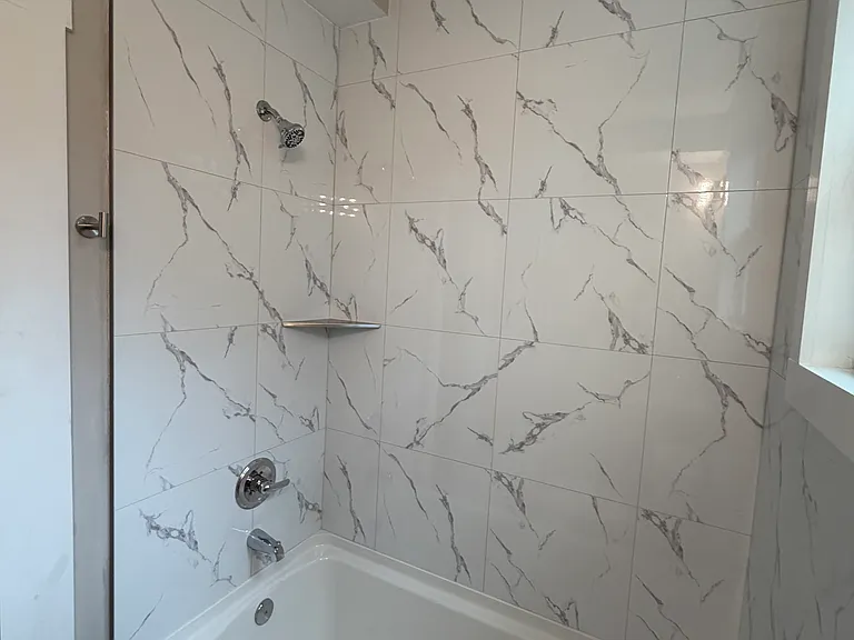 Fully renovated bathroom, new tiles and tub. New toilet.