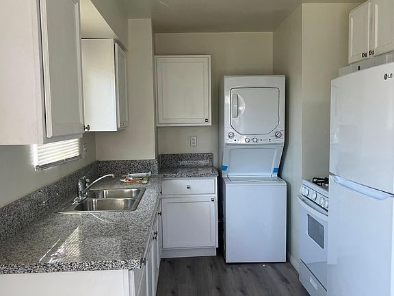 Closer look at kitchen and appliances Brand new cabinets, counter top, refrigerator, stove, microwave, washer/dryer