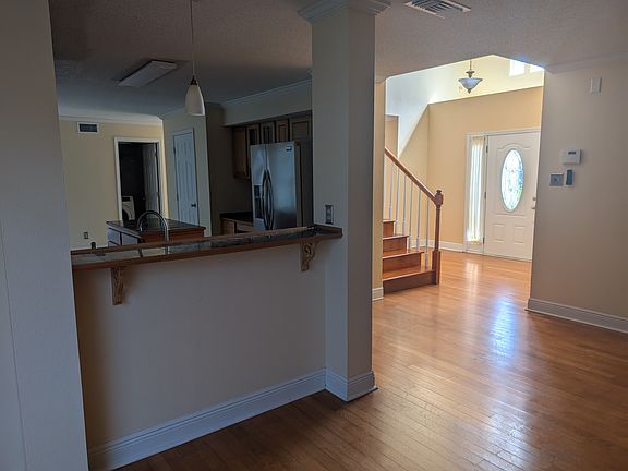 Facing kitchen bar from living room