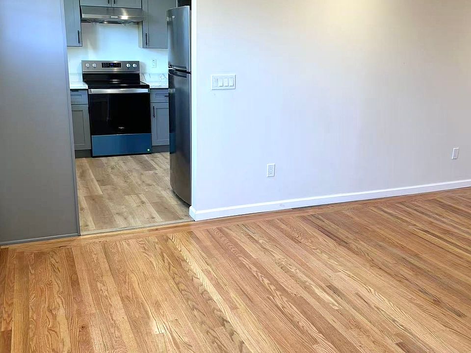 Kitchen and living room with BRAND-NEW flooring, newly textured and painted walls, and NEW mini-split air conditioner system.