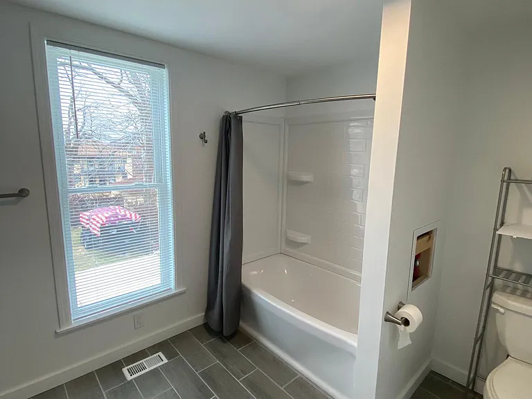 Recently remodeled and spacious upstairs full bath with double vanity.
