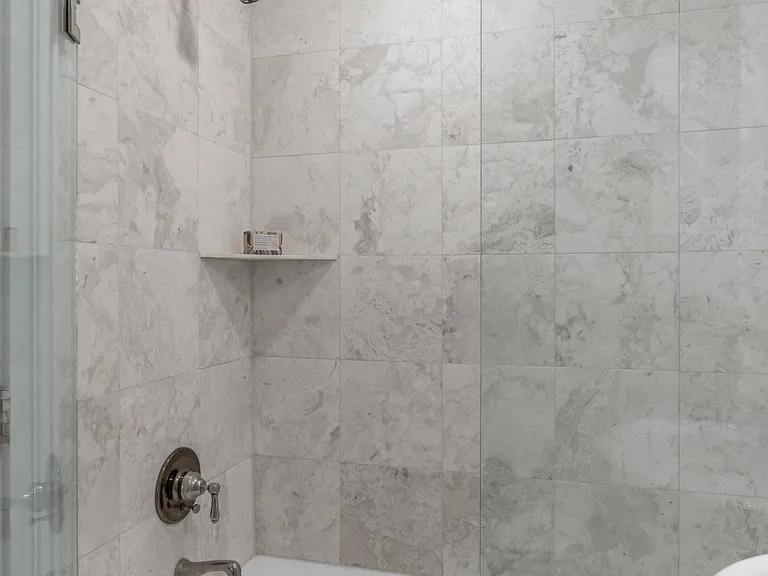 Third floor guest bath shower, with full tile and glass enclosure.