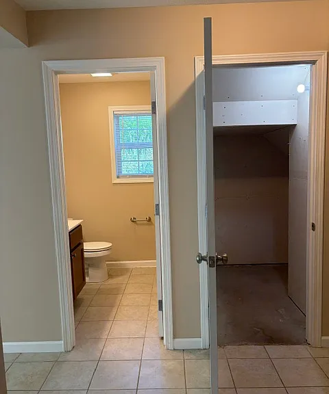 Half BA off Kitchen and Entryway; Additional storage area under stairs
