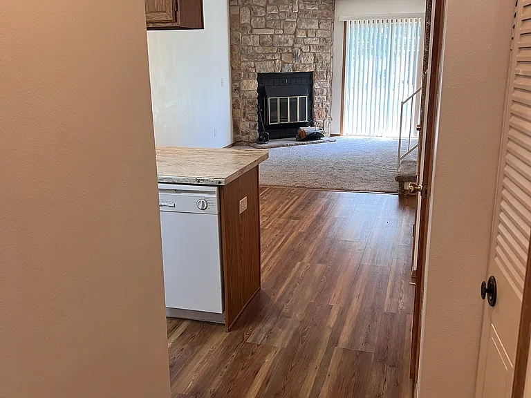 View from the front door. Kitchen on the left, coat closet, pantry, half-bathroom and additional storage closet on the right.