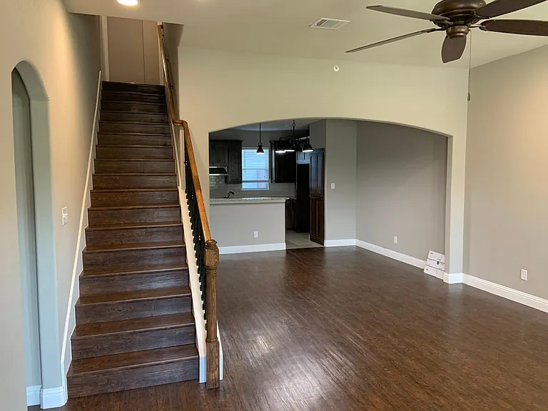 Entry view of living room, kitchen and stairs