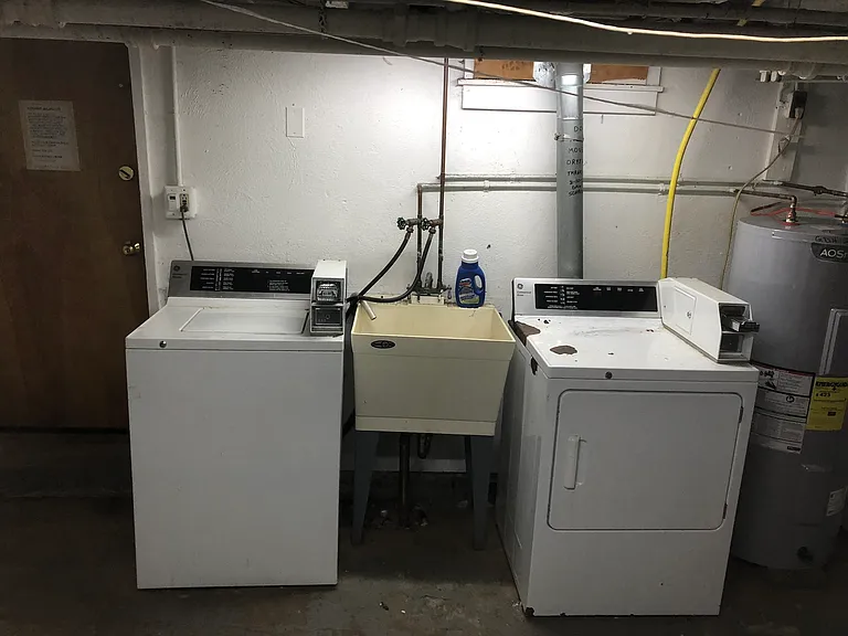 well lit clean washer and dryer in basement for all