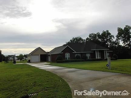 View from street
						:
						Lots of concrete for bike riding. Simple landscape for easy maintenance.