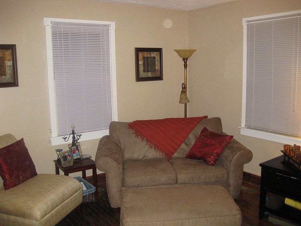 The living room has been freshly painted and has dark hardwood floors.