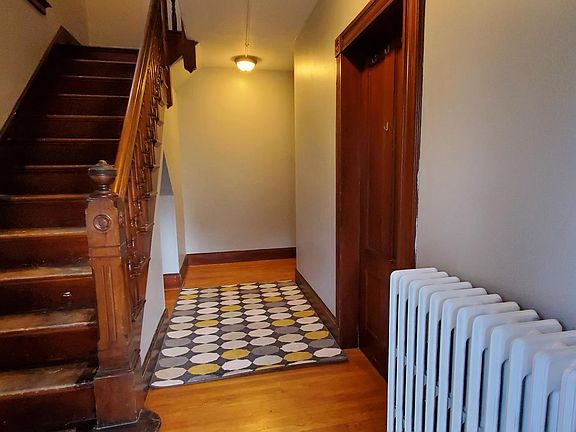 Front entrance with storage under the stairs.