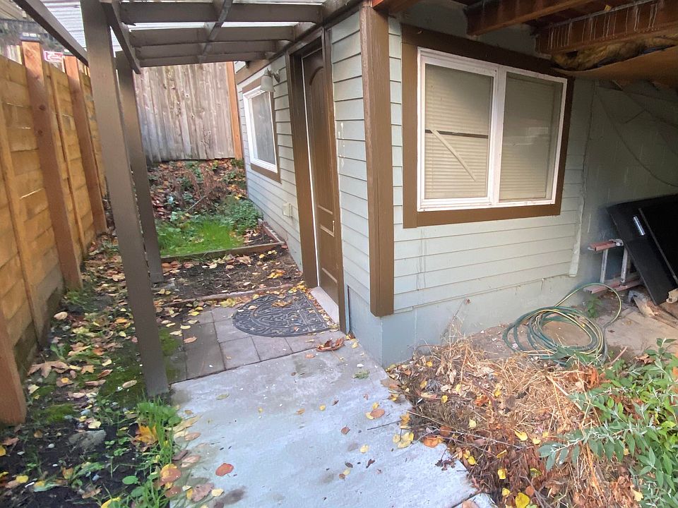 Separate entryway for the lower unit with a private walkway and large covered storage area