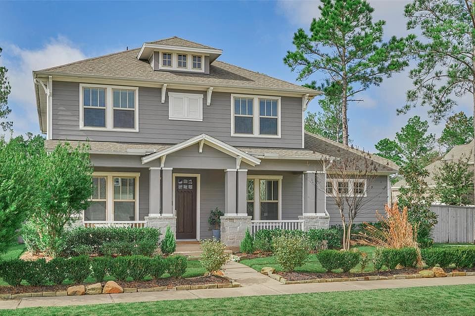 Welcome to 23 Glory Garden Way! The property features a contemporary Craftsman style exterior with a large and inviting front porch!