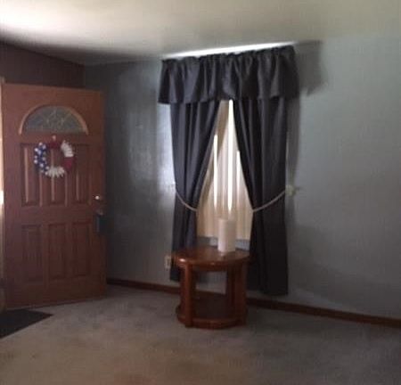 Living room with W/W capreting.  Large front window for natural light.