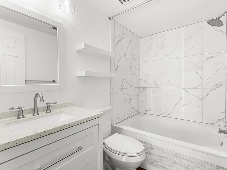 Updated ensuite bathroom with a spacious vanity offering ample storage, plus a soaking tub and shower.
